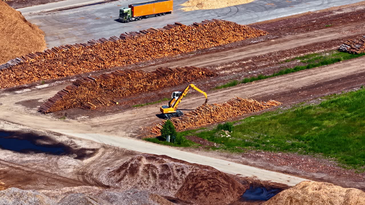 Industrial site lumber processing facility with large piles of raw wood byproducts