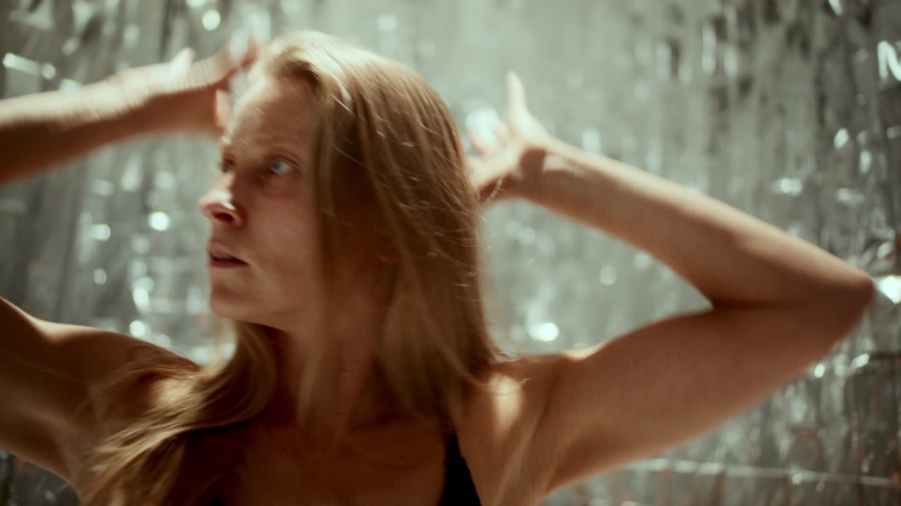 Female Dancer Performing Gracefully against Silver Background