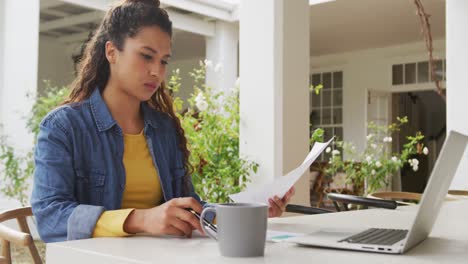 Video-of-biracial-woman-using-laptop-in-the-garden