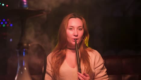 woman smoking hookah in a lounge