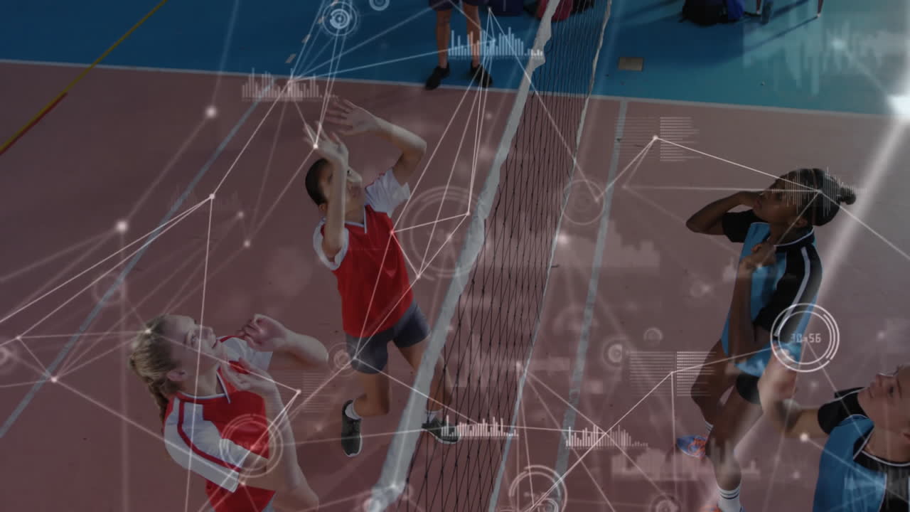 Teenage volleyball players leaping at net in gym showing sports analytics with graphics and data