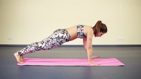 doing hand exercises from horizontal plank while practising yoga. fitness and wellbeing.