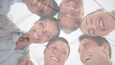 network of connections against group of diverse office colleagues forming a huddle at at office