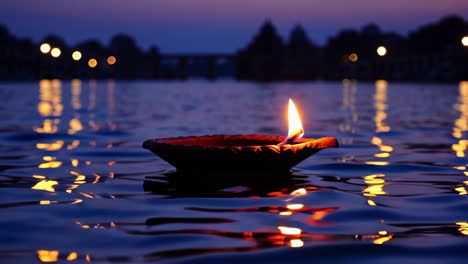 diya floating on water at sunset