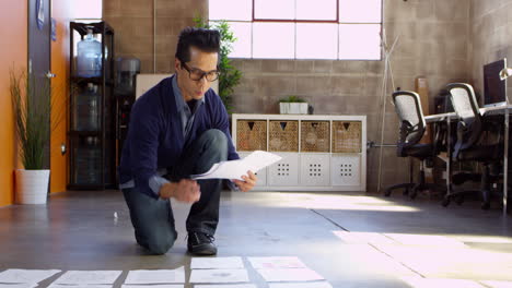 designer plans layout on floor of modern office shot on r3d