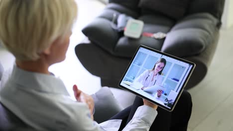 woman engaged in a virtual doctor consultation via tablet