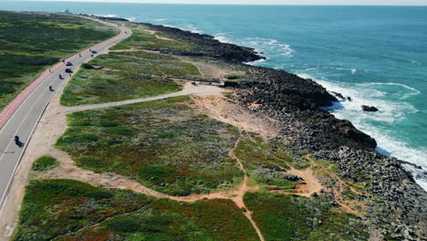 aerial view seashore road running along rocky coast. transport riding on highway