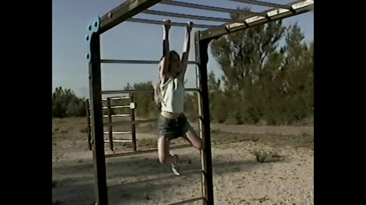 Girl playing on monkey bars
