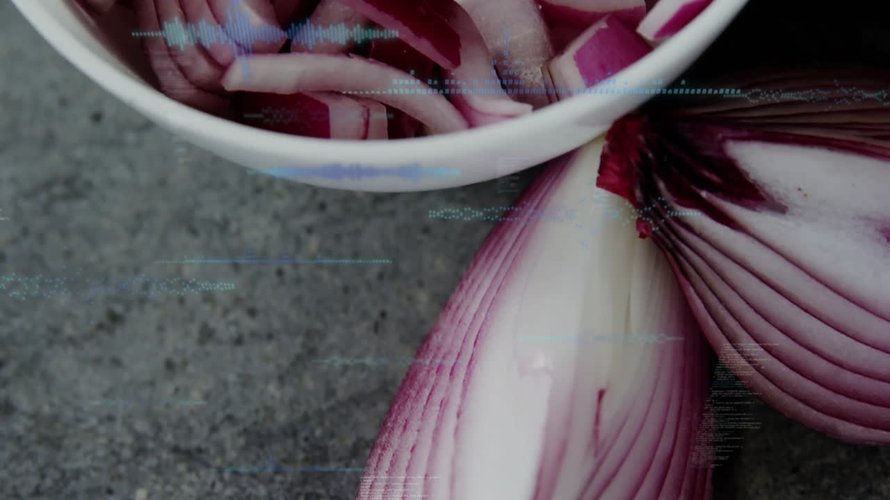 Sliced red onions in bowl with digital data processing animation overlay