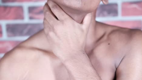 man touching his throat