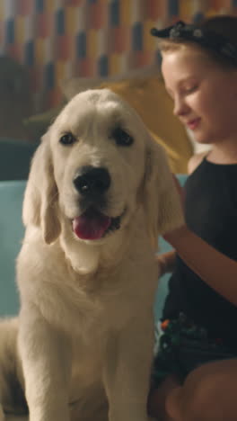 child playing with a puppy on a couch