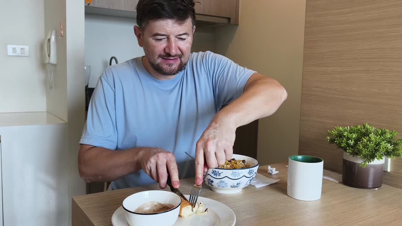 A man is eating breakfast at a table