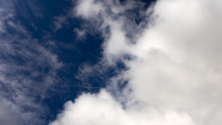 Looking Up On White Clouds In The Blue Sky