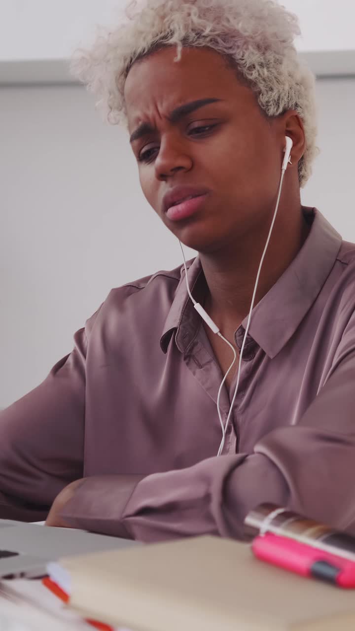 Focused student deep in thought while studying at home in a bright kitchen
