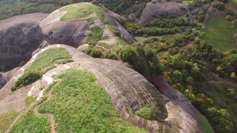 Beautiful-aerial-as-climbers-summit-a-sheer-rocky-cliff-face-in-Meteora-Greece-1