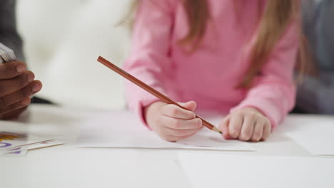 girl writes letters learning english language with teacher