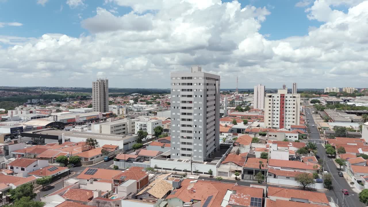 Aerial flying backwards from buildings in residential neighborhood. Bauru, Brazil