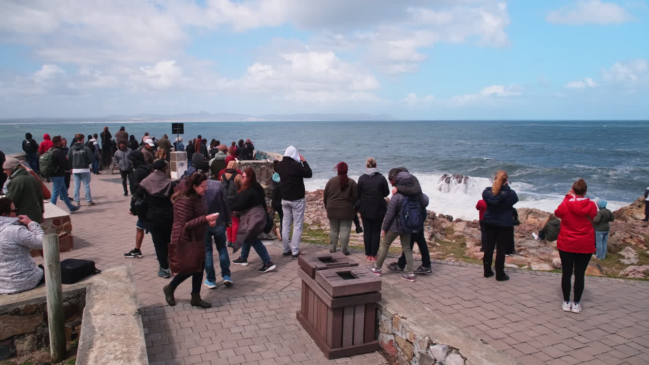 Bunch of tourists in Hermanus whale watching at famous Gearing's Point