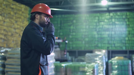 warehouse worker in hard hat communicating
