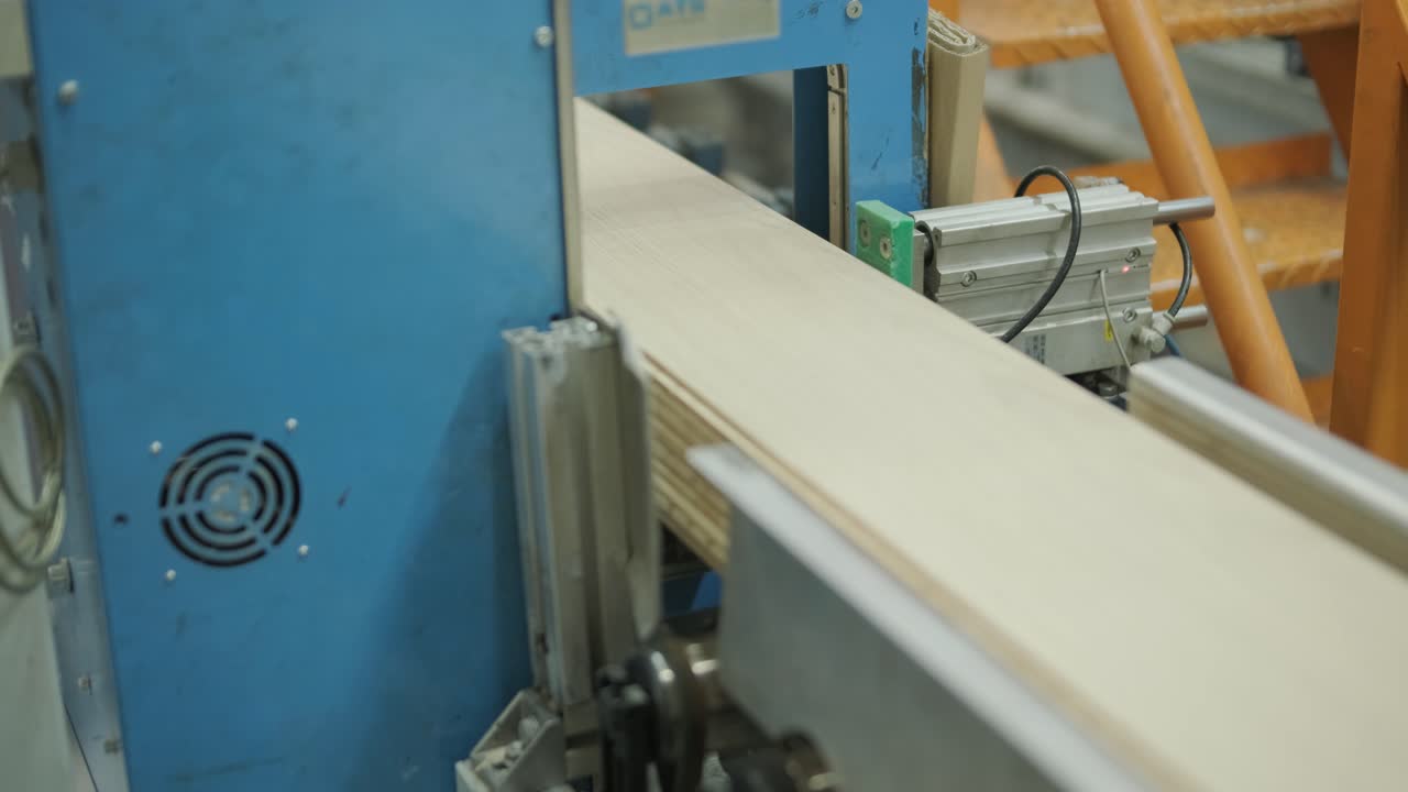 Wooden Planks Being Processed and Stacked by Industrial Machine