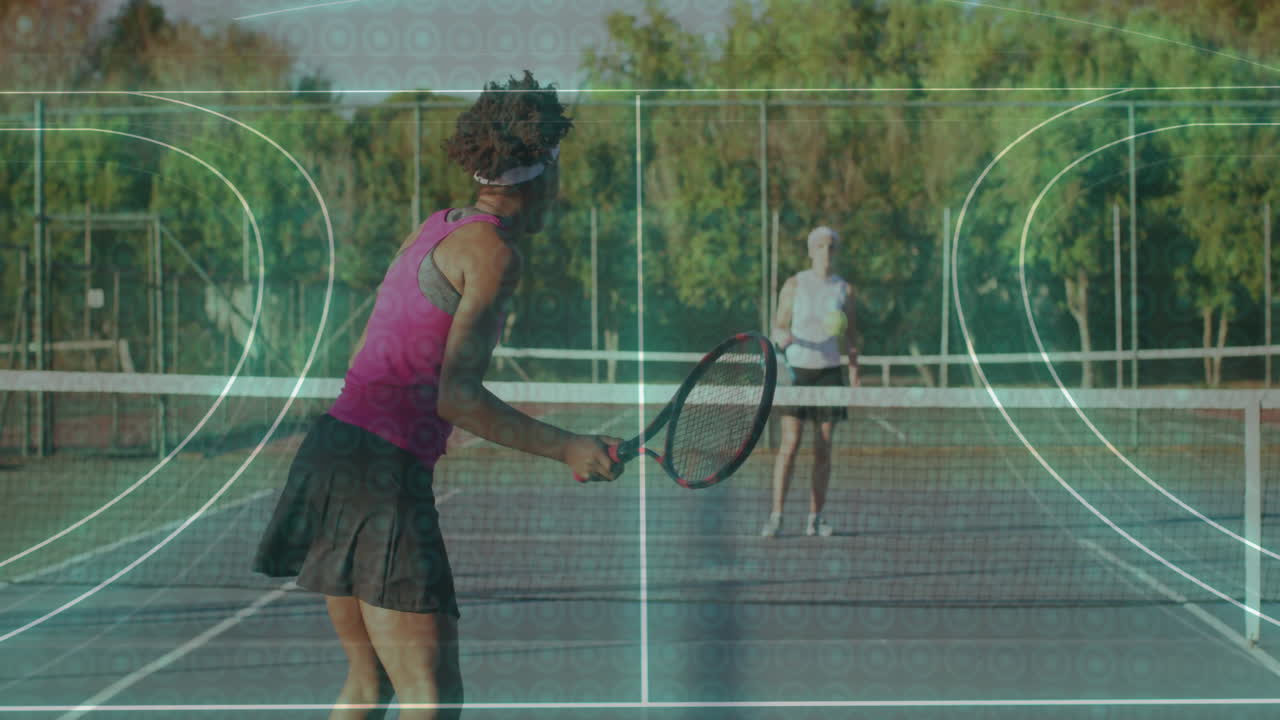 Female duo rallying on clay tennis court showing animated trajectory and speed chart for technology