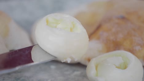 butter on a knife with pita bread
