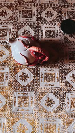 octopus teapot on patterned tablecloth