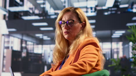 businesswoman working on laptop in modern office