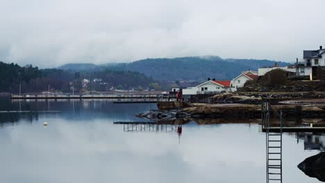 coastal houses reflect on still havstensfjorden in ljungskile, bohuslan, sweden