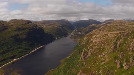 A tranquil norwegian landscape, showing mountains and a winding river, aerial view