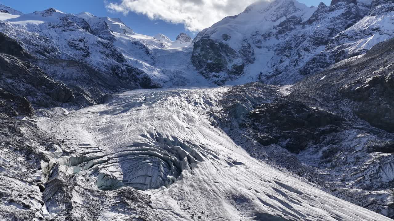 Engadin valley near St Moritz Switzerland with wide glacier and snowy mountains with drone pulls back