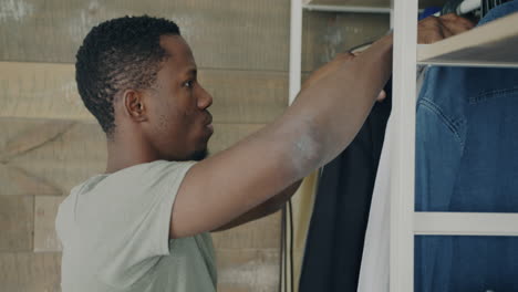 man choosing clothes in a wardrobe