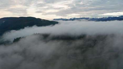 aerial view of foggy mountains moving sideways