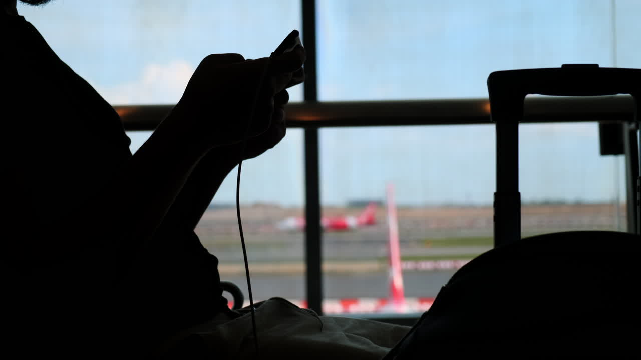Person using smartphone at airport
