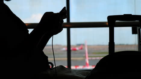 person using smartphone at airport