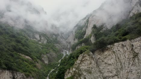 misty mountain valley with waterfall