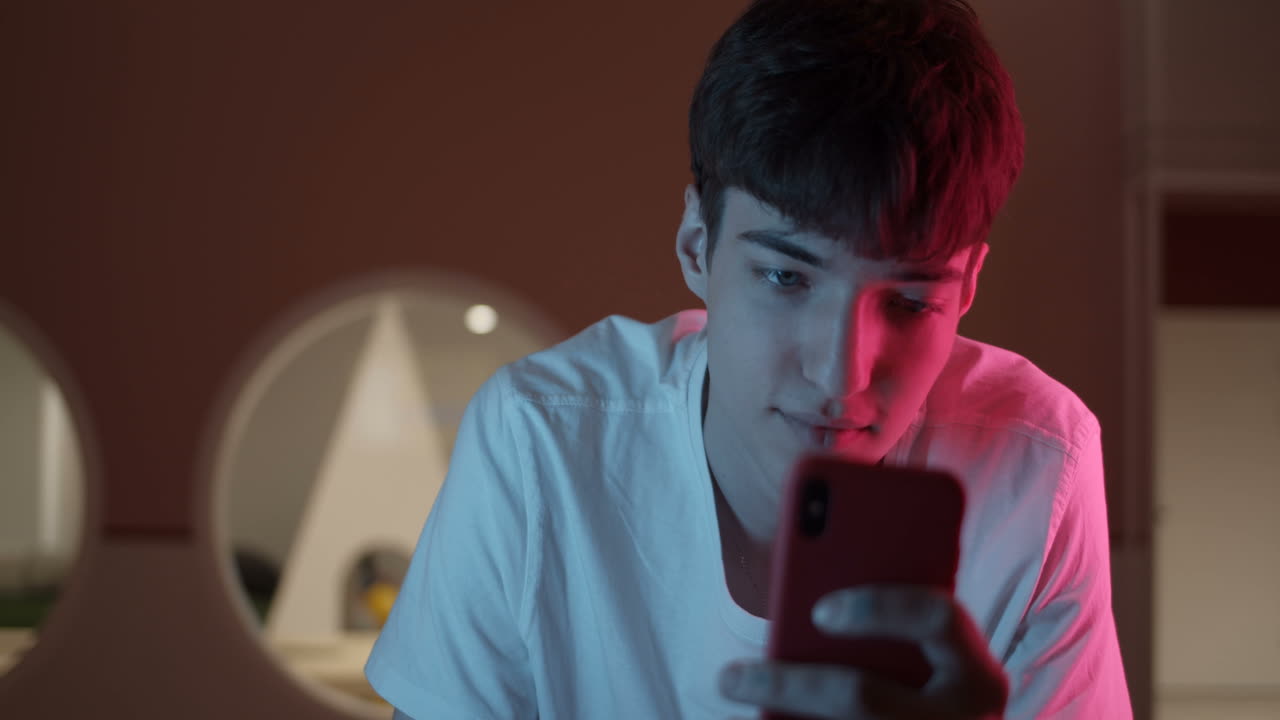 Teenager using smartphone indoors
