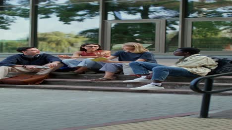 students discussing on campus stairs