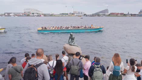large crowd of people near iconic little mermaid statue in copenhagen