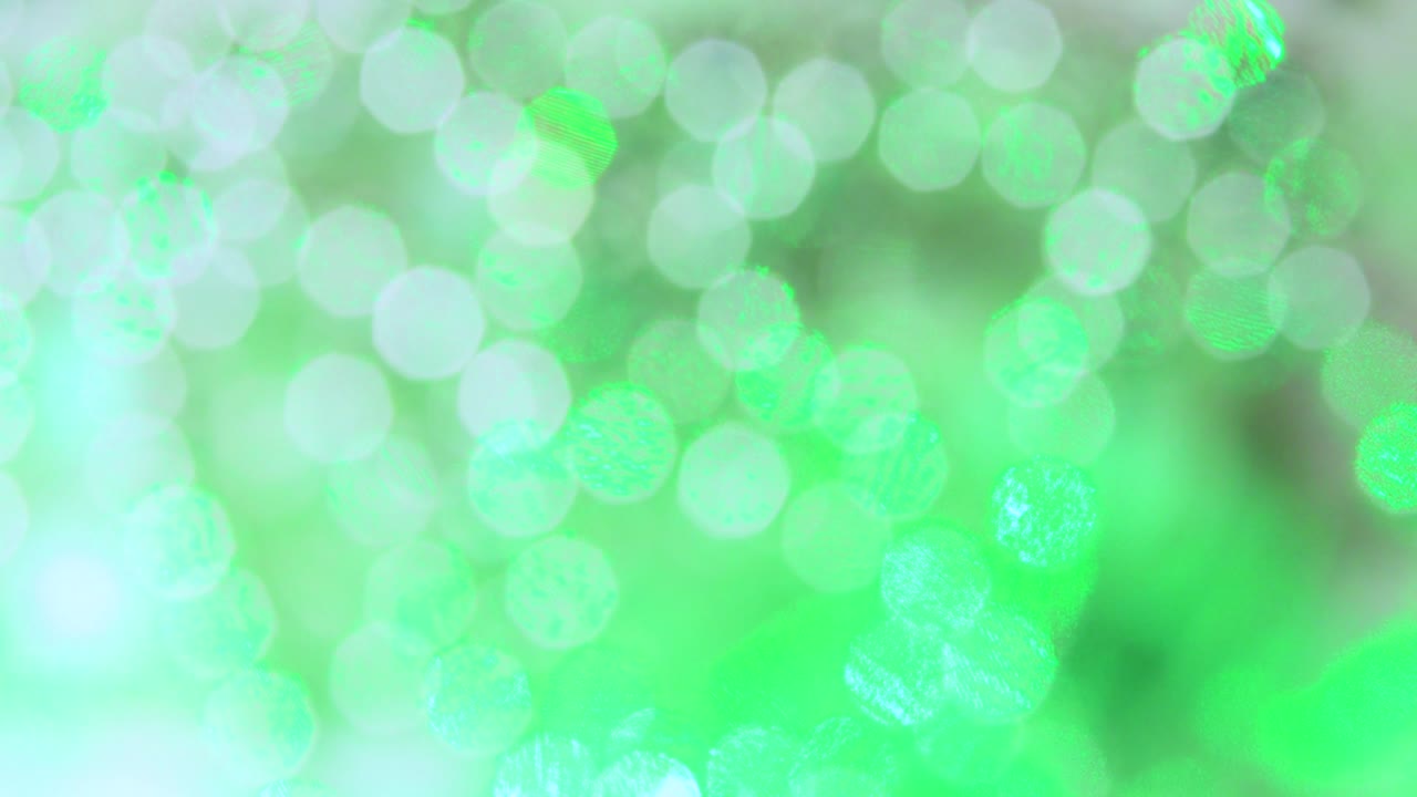 Weiße Weihnachtslichter und ein grüner Strahl erzeugen ein wunderschönes Bokeh.