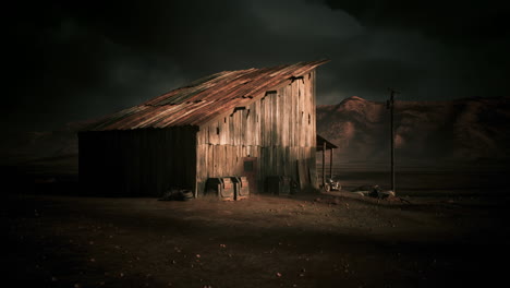 abandoned barn in a desolate landscape under dark storm clouds at dusk