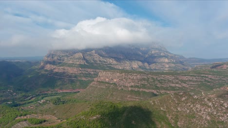 impressive landscape of sant salvador de les espases with clouds at top