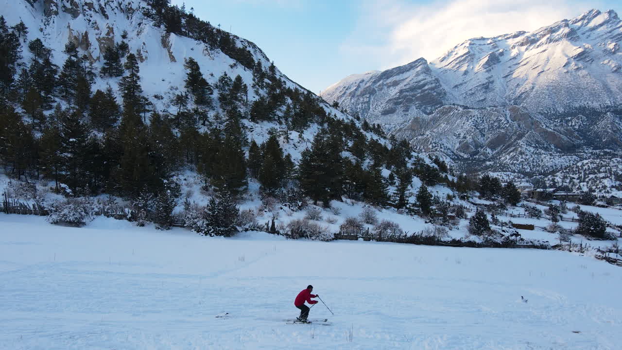 Skiing fun Drone shot in the mountain region of Annapurna Nepal, a man skis in a snow capped shiny moutains and adventurous manag tourism activity