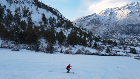 skiing fun drone shot in the mountain region of annapurna nepal, a man skis in a snow capped shiny moutains and adventurous manag tourism activity