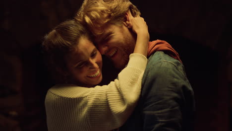 Smiling-lovers-dance-on-date-night-closeup.-Couple-having-fun-by-fireplace