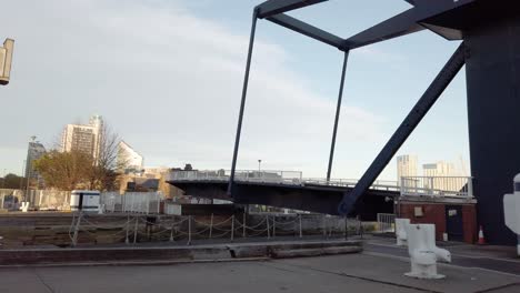 Rising-Drawbridge-called-The-Blue-Bridge-in-Isle-of-Dogs,-London,-UK