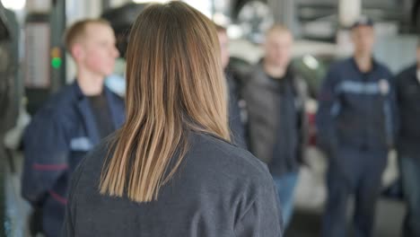 female manager discussing vehicle repair with mechanic in auto repair shop