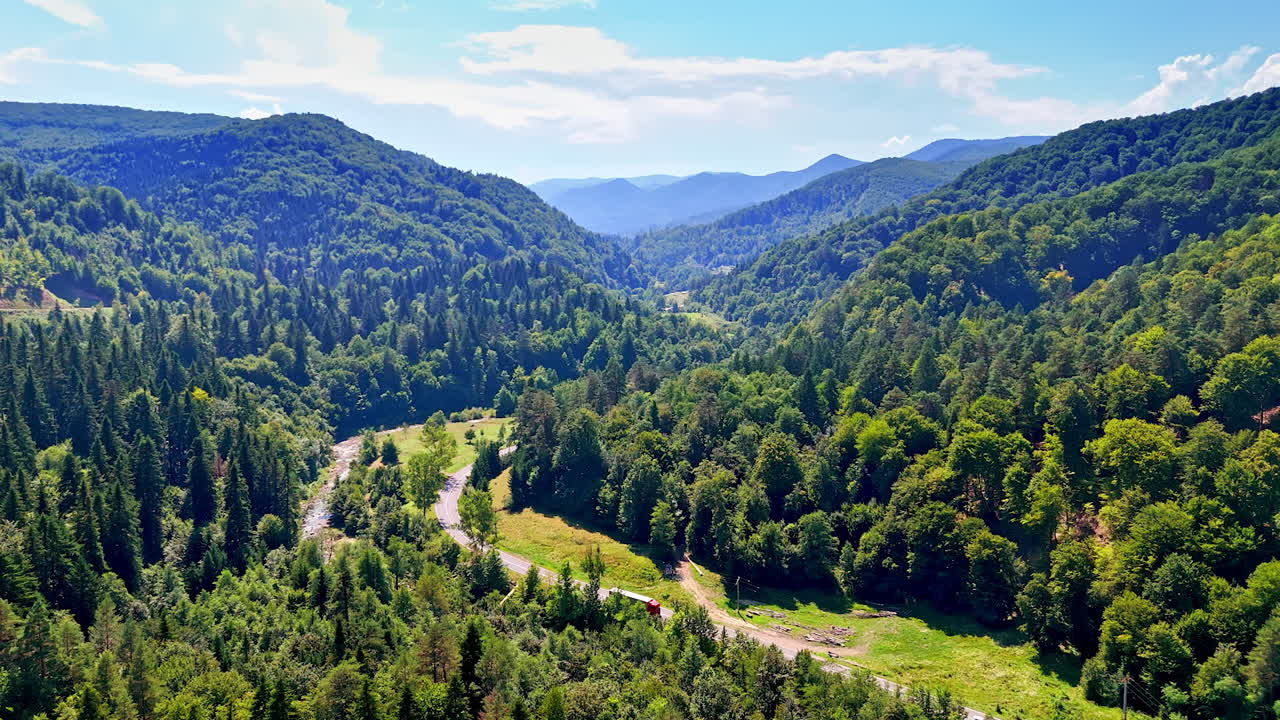 Misty clouds drifting over the mountain spine. The weather creates a moody atmosphere around the sharp stone formations