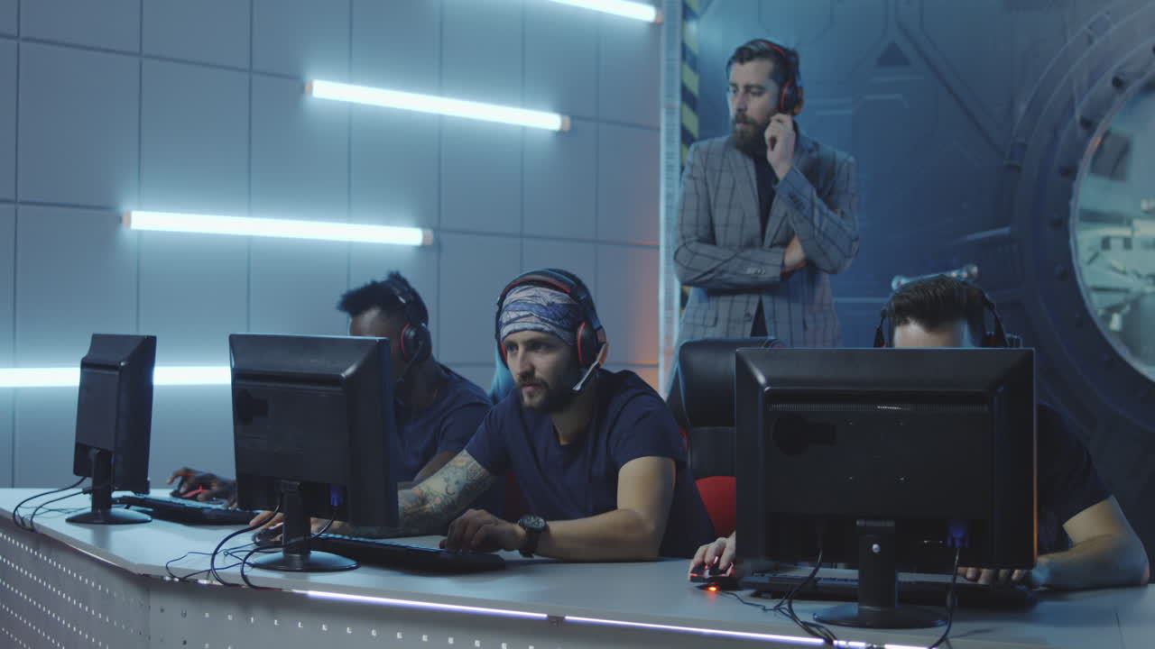 Man Hosting a Gaming Tournament Medium Shot of a Young Host in Suit Watching Gamers Playing at a Gaming Tournament