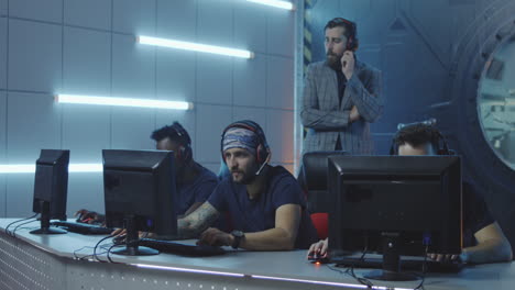 man hosting a gaming tournament medium shot of a young host in suit watching gamers playing at a gaming tournament